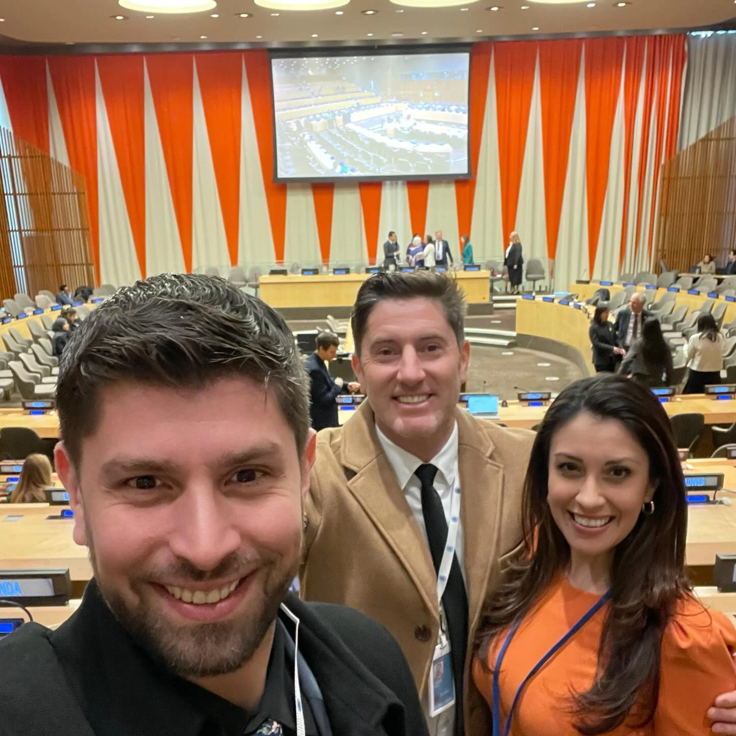 Three attendees photographed inside the ECOSOC chamber.